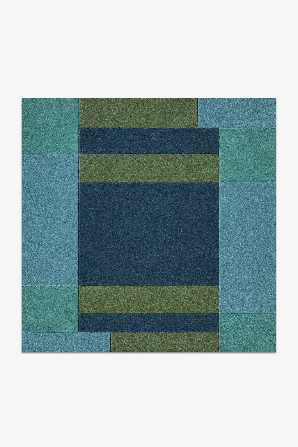 square rug with a geometric pattern of blue and green squares on a white background