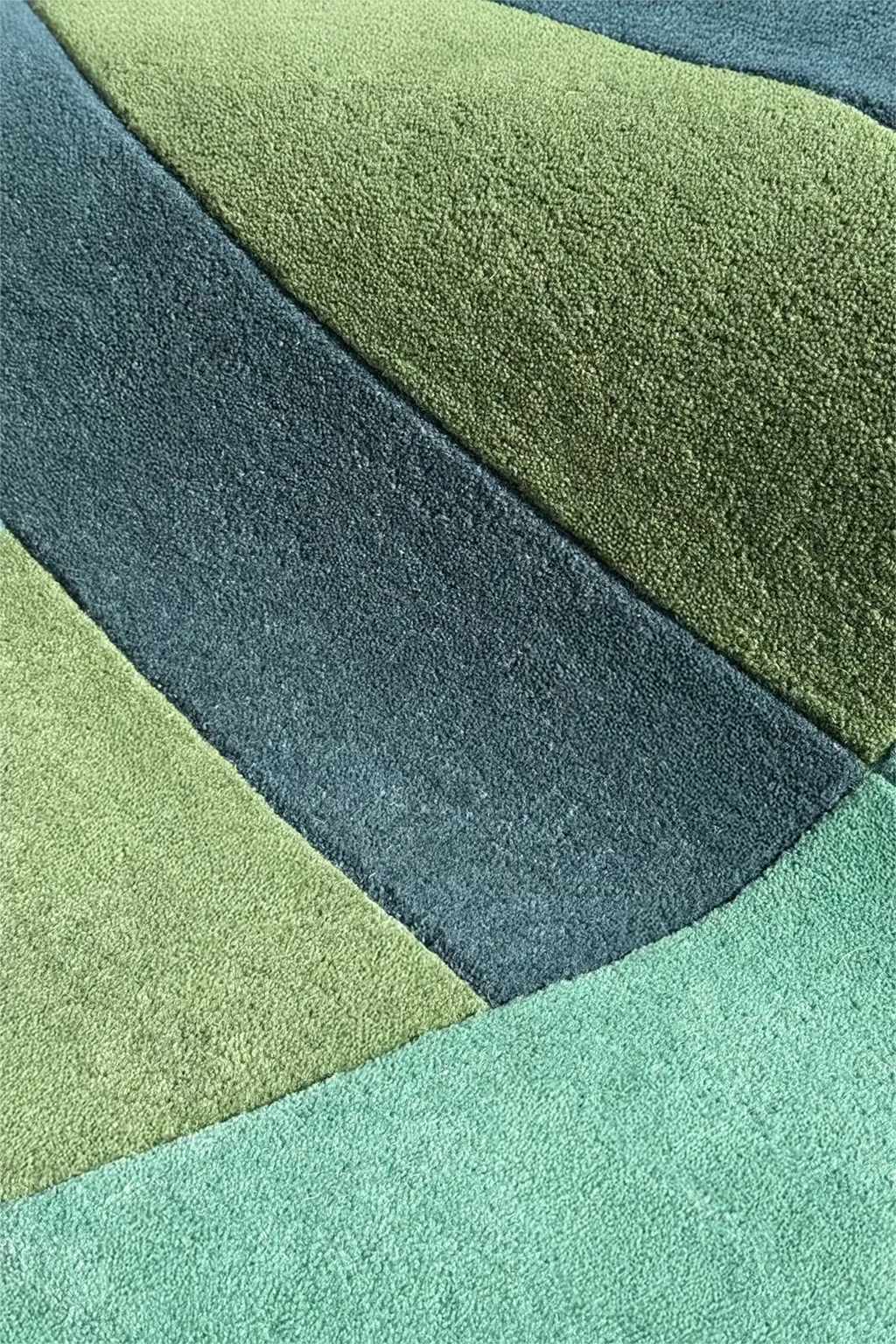 close-up texture of teal green and blue square rug