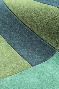 close-up texture of teal green and blue square rug