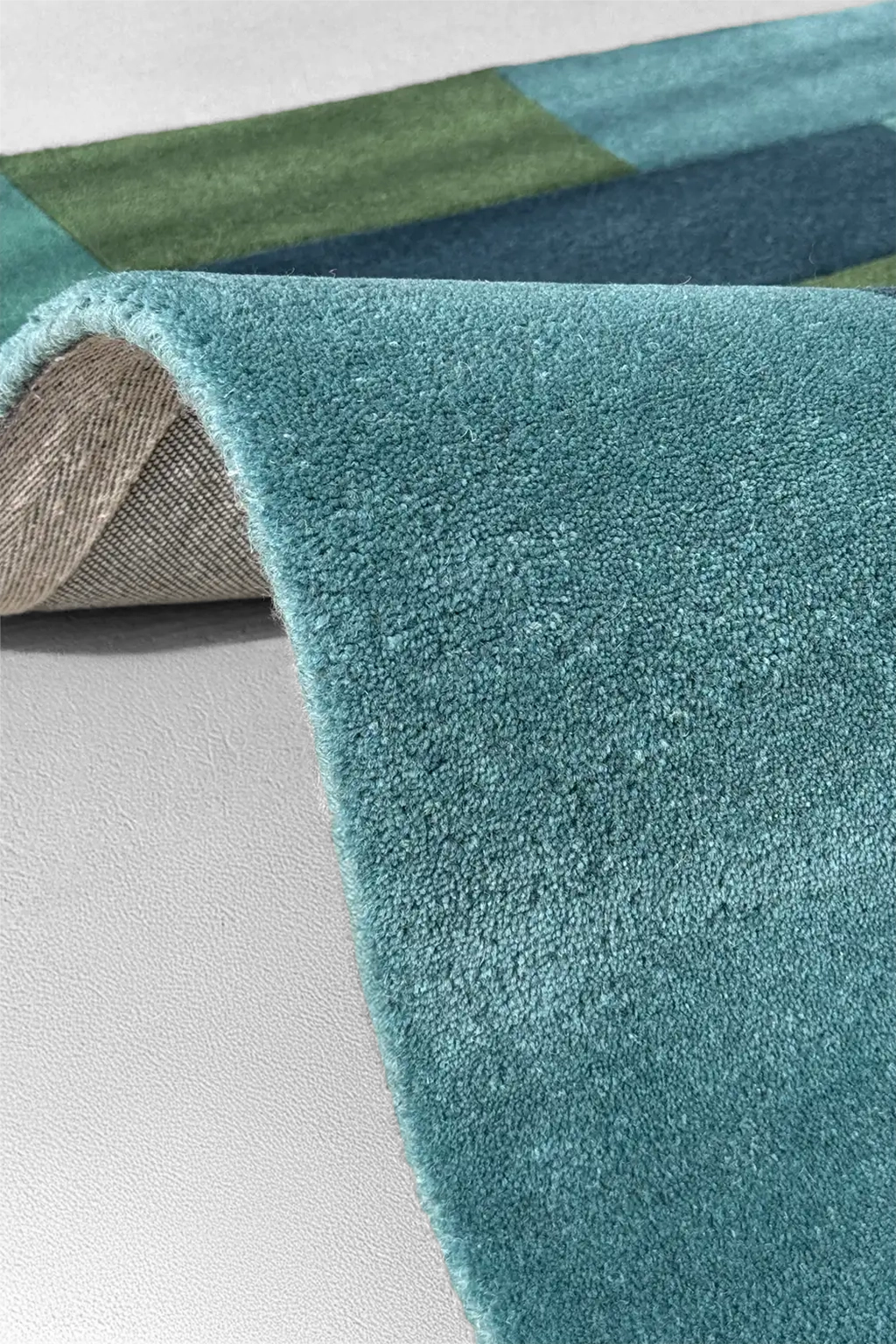 teal square rug with hand-tufted wool pile