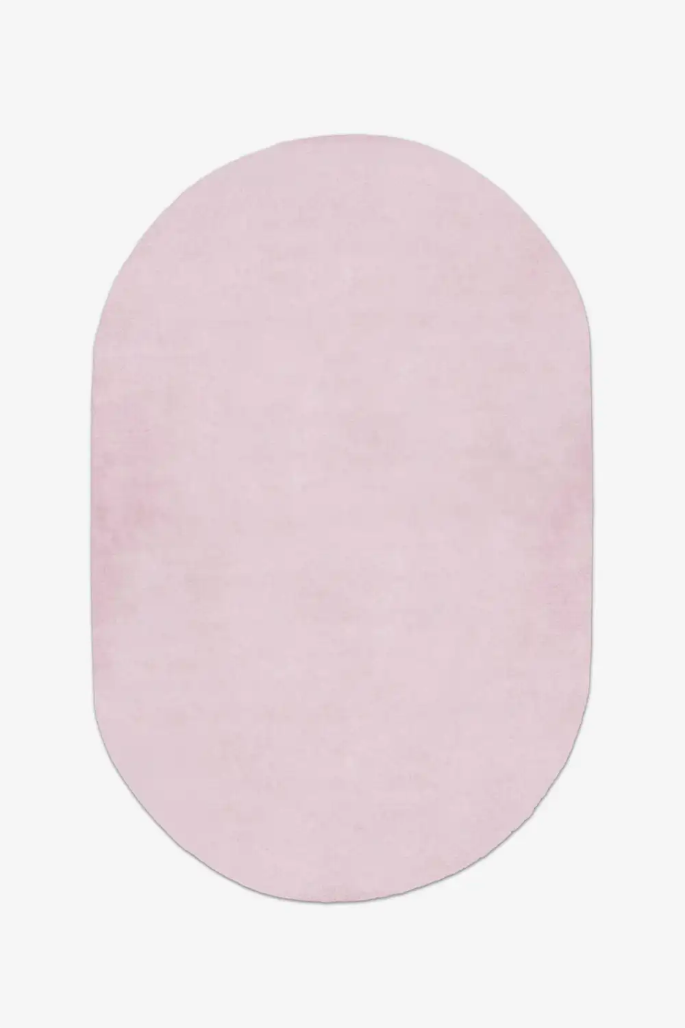 soft light pink oval rug on a white background