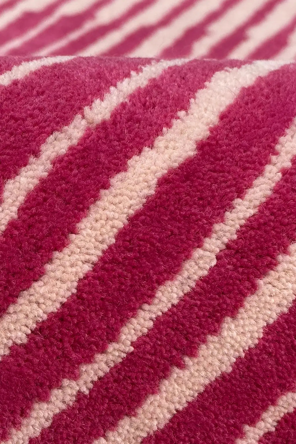 Close-up of a hot pink and white striped wool rug texture