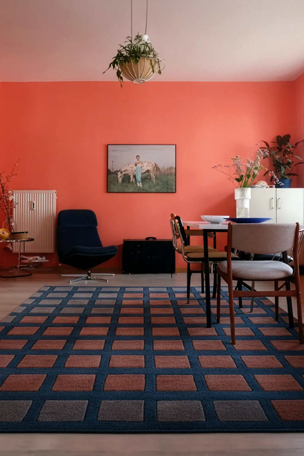 large deep teal rug with rust and gray squares in a modern southwestern living room lifestyle