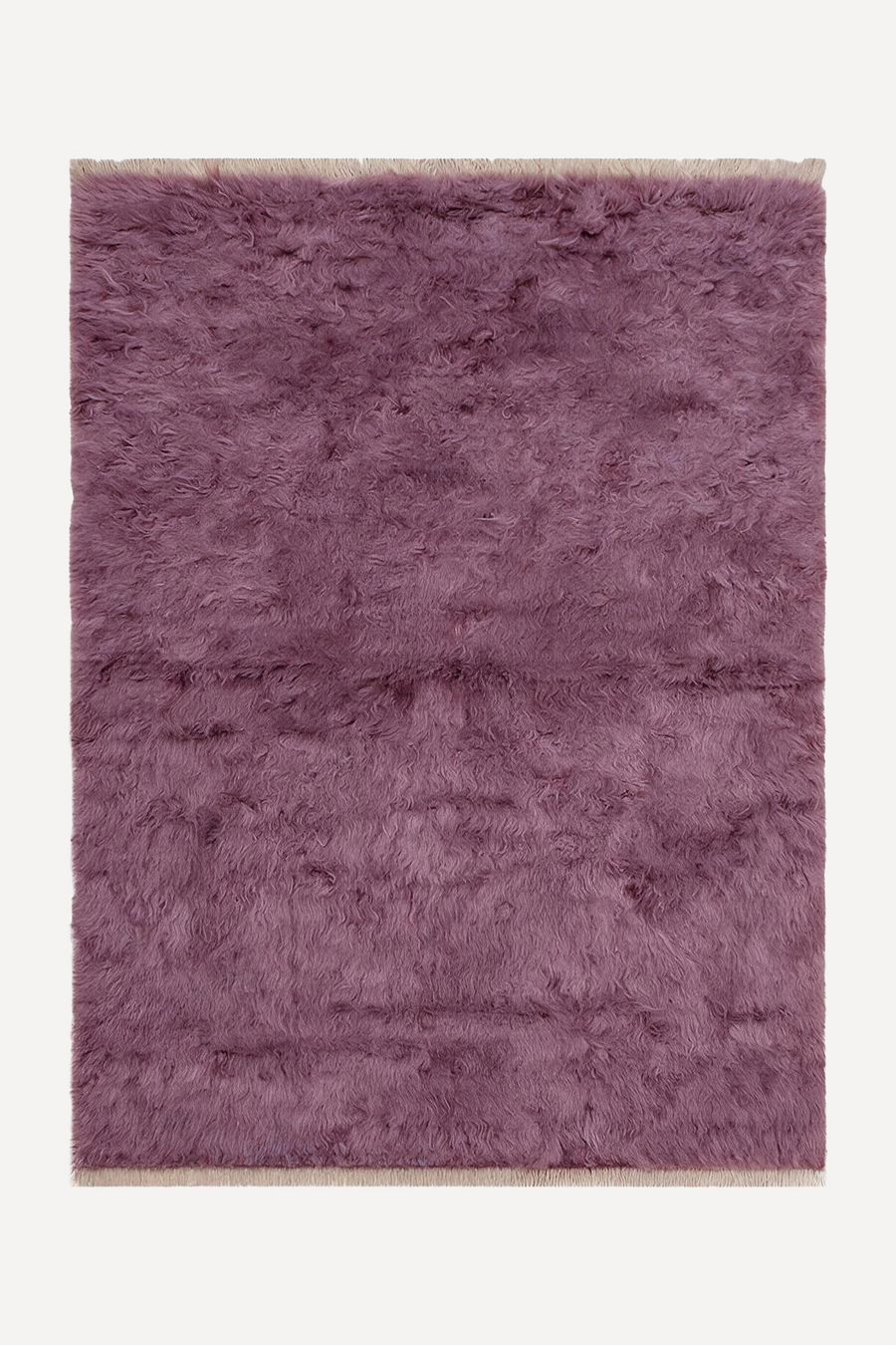 A rectangular shaggy area rug in a dusty mauve-purple color, shown flat against a clean off-white background.