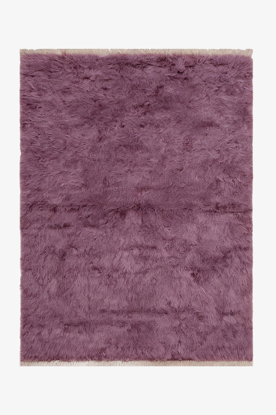 A rectangular shaggy area rug in a dusty mauve-purple color, shown flat against a plain white background.