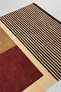 Neutral wool area rug in 4x6 with midcentury color blocking in burgundy, tan, and black