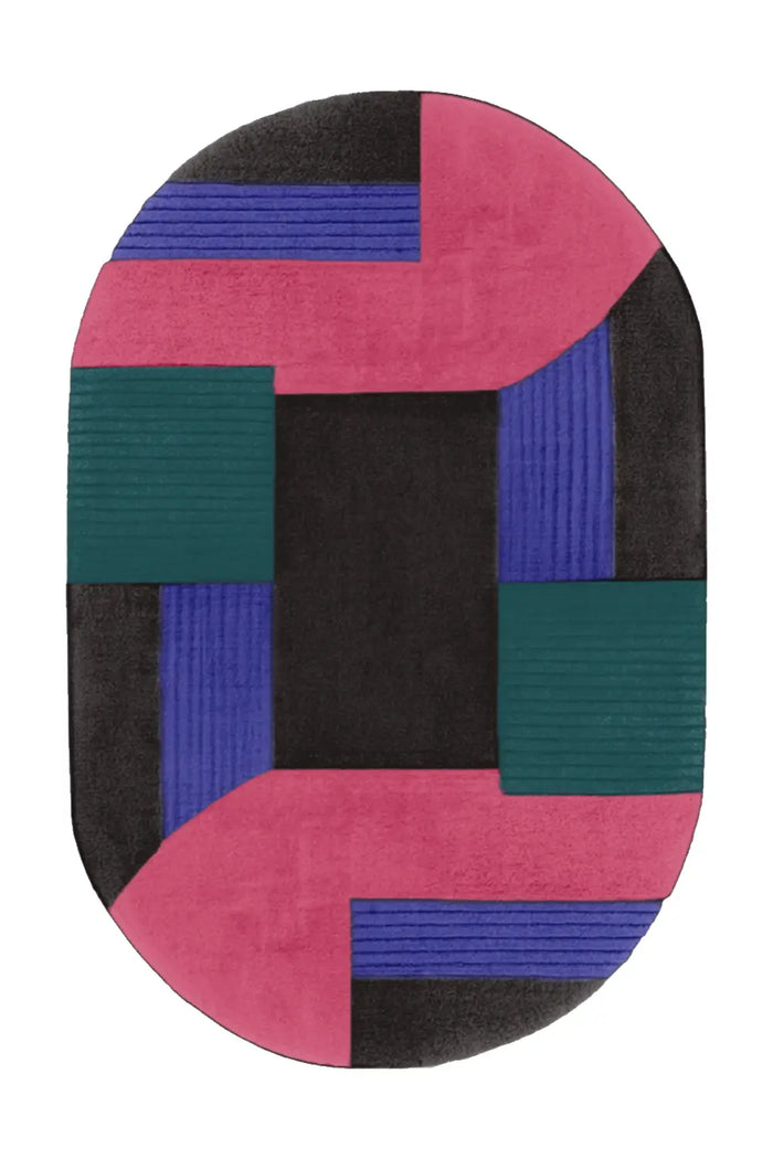 Black, pink, and green oval wool rug with modern abstract color blocking and sculptural hand-tufted texture