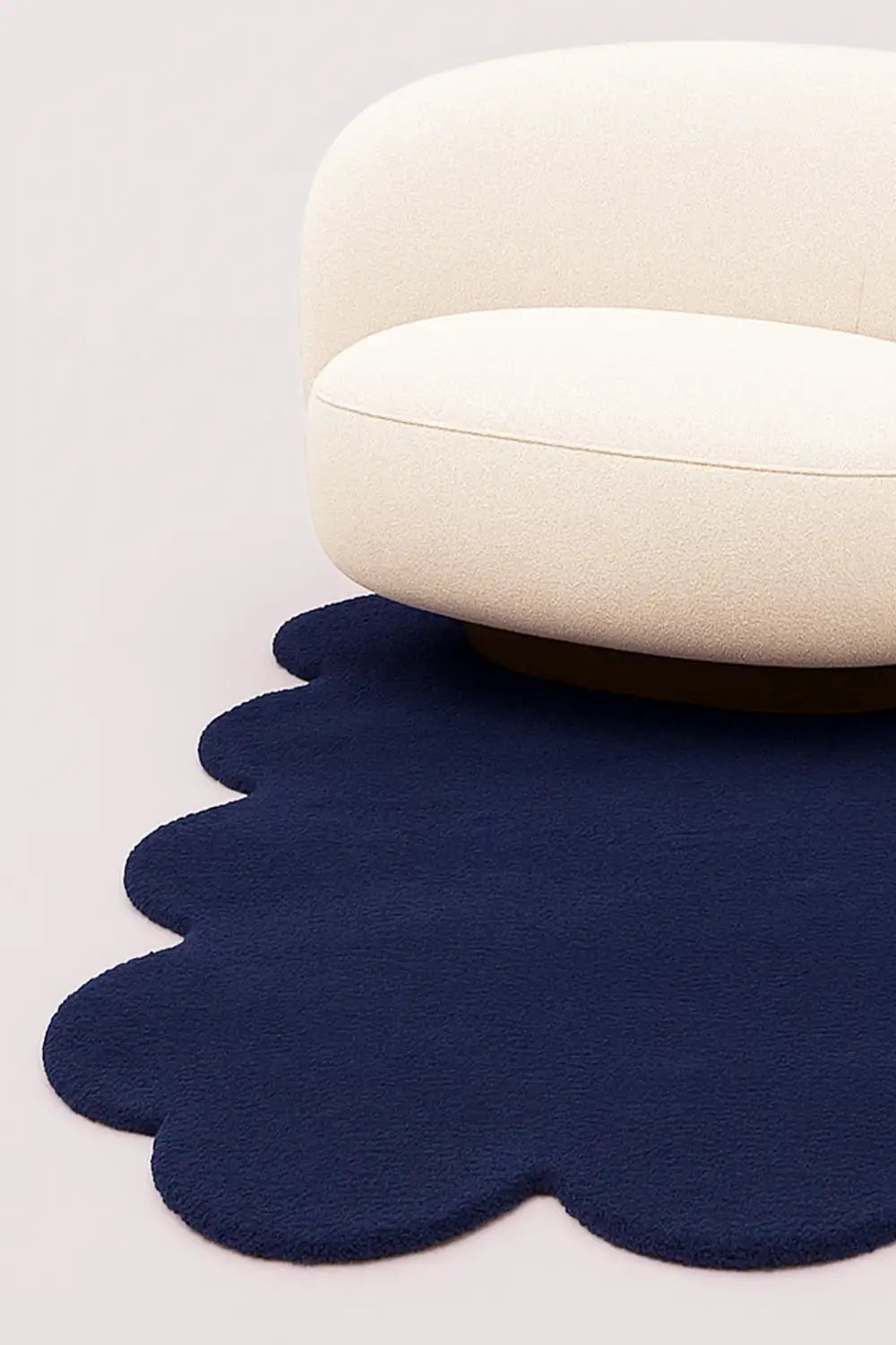 Bold navy scalloped rug styled under white boucle chair, perfect as a cool custom rug for living rooms