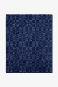 Navy blue textured rug on a white background
