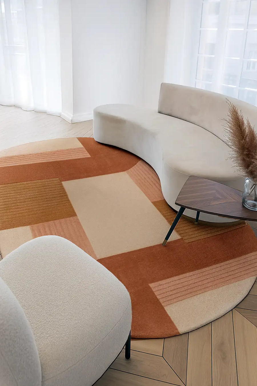 orange tan and peach 8x10 oval rug in a modern sun-lit neutral living room