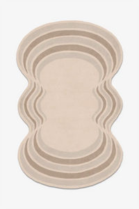 irregular shaped wool rug with wavy edges on a white background