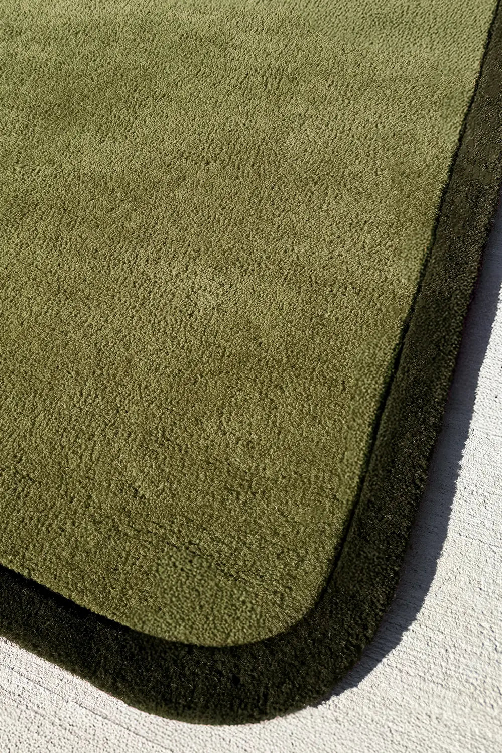 Olive green runner rug corner detail with bold dark trim, custom wool hallway rug