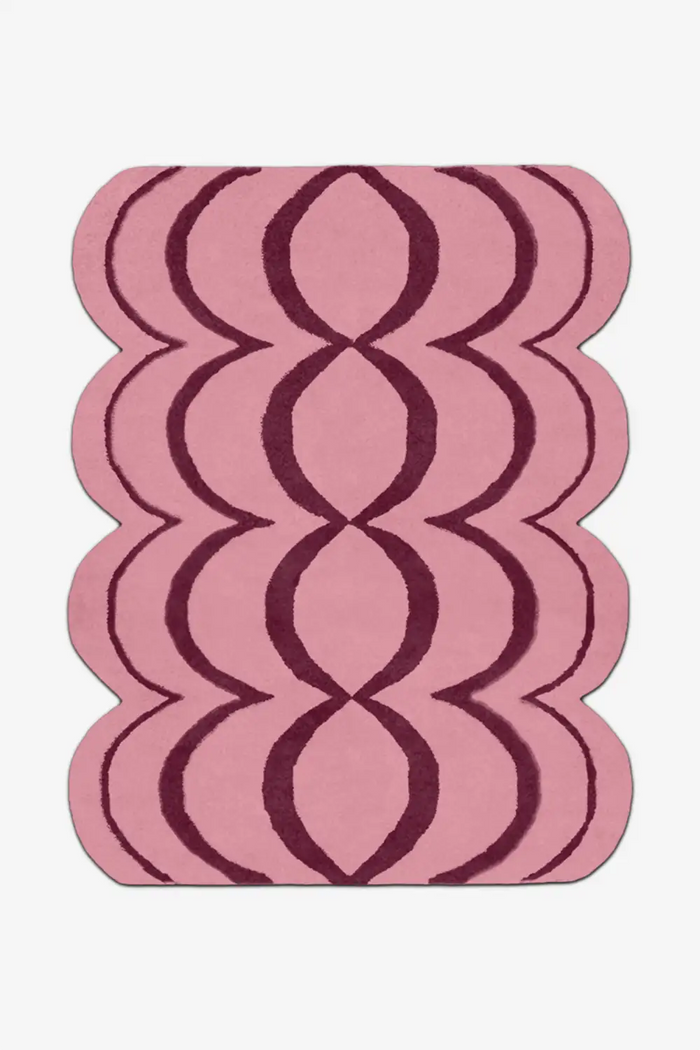 Pink wool rug with wavy deep red lines on a white background