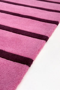 Close-up of a pink and purple striped extra long runner rug texture on a white background