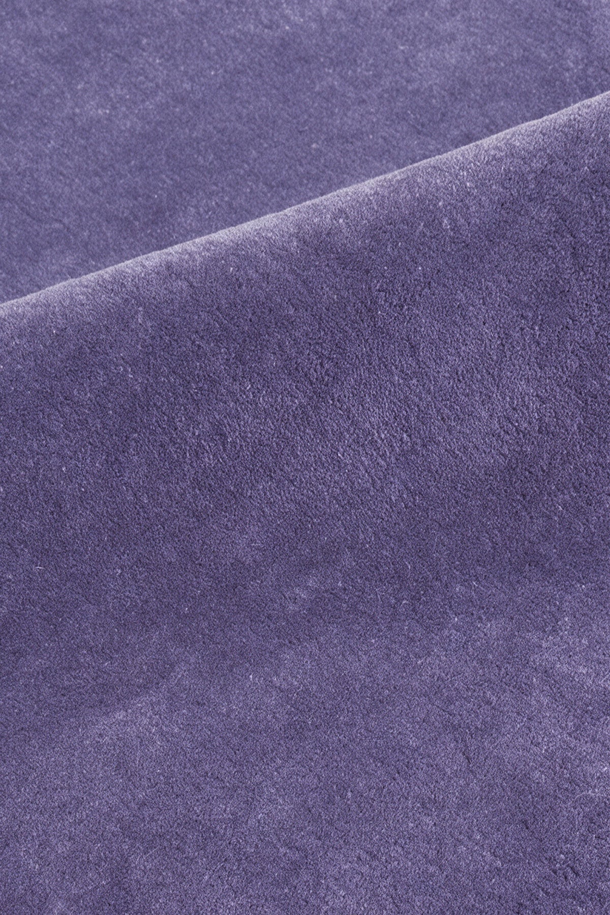 close up of the soft cut pile on a purple cornflower hand-tufted wool rug