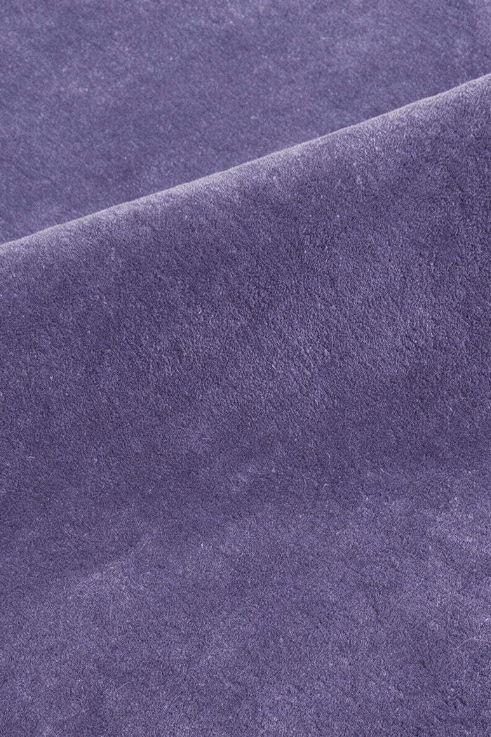 close up of the soft cut pile on a purple cornflower hand-tufted wool rug