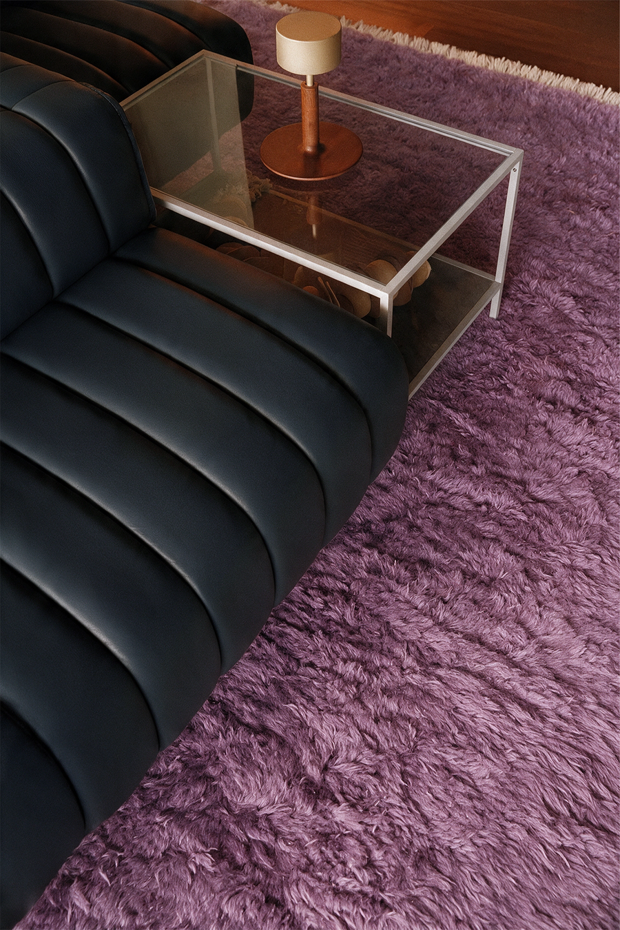 modern living room with w a blue leather couch on top of a mauve purple shaggy wool rug lifestyle