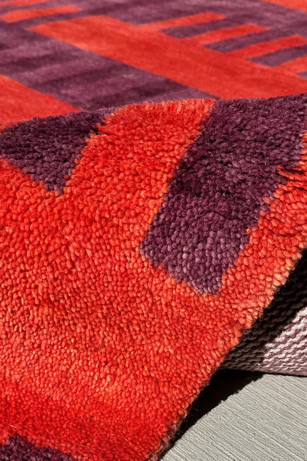 Close-up of a red and purple textured rug