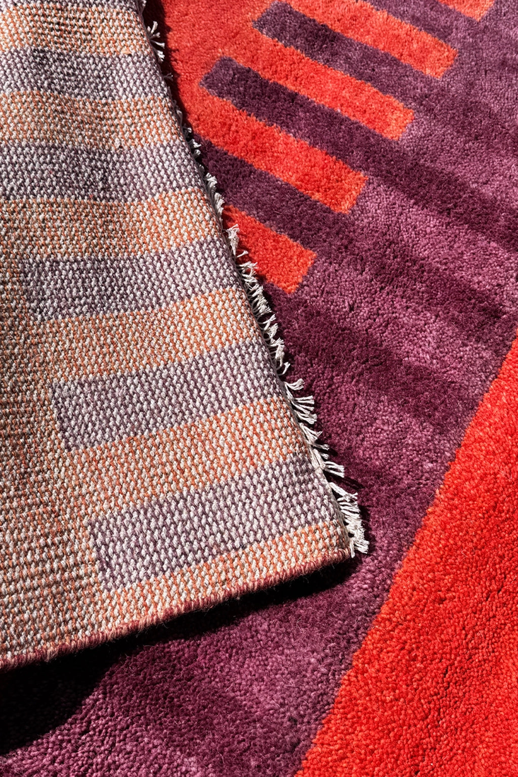 red and purple striped square rug texture