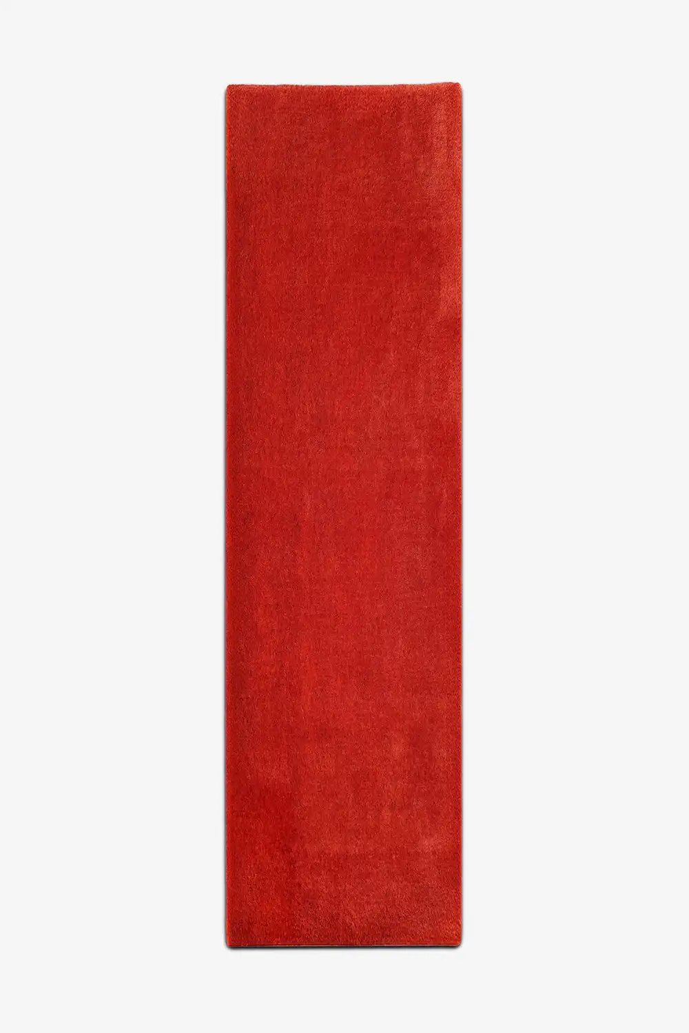 red wool runner rug with vibrant orange undertones on white background