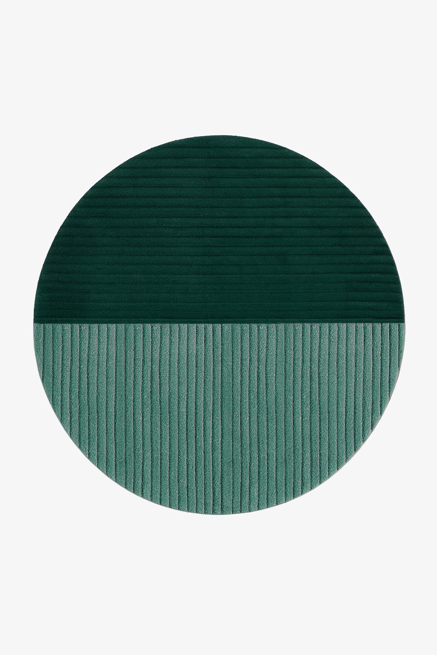 A round area rug with a split design, featuring a dark forest green top half with horizontal ribbing and a muted teal-green bottom half with vertical ribbing, shown on a plain white background.