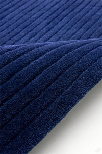 Close-up of blue textured rug with pleated pattern