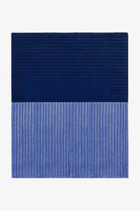 Blue textured rug on a white background