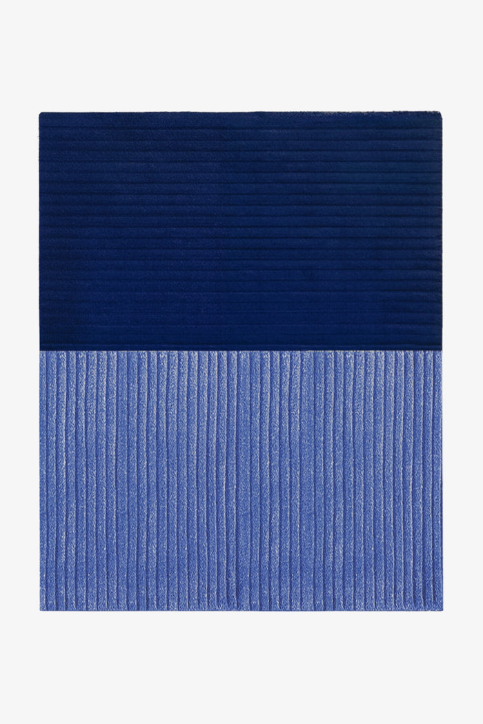 Blue textured rug on a white background