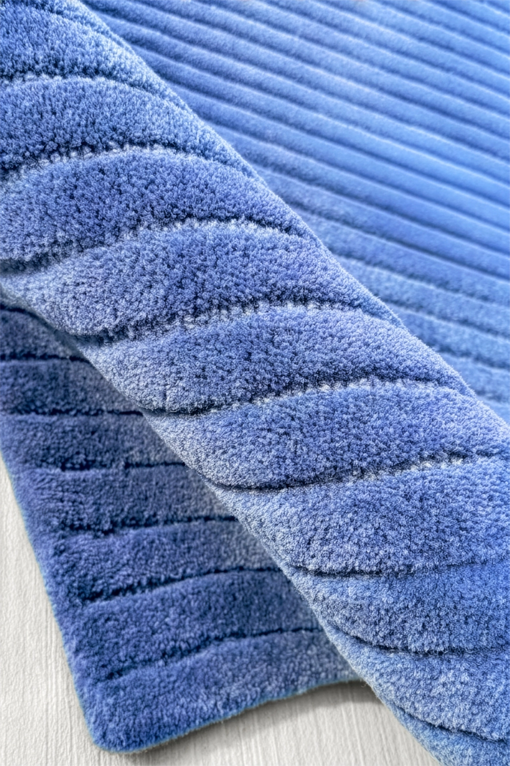 Blue textured rug on a light wooden floor