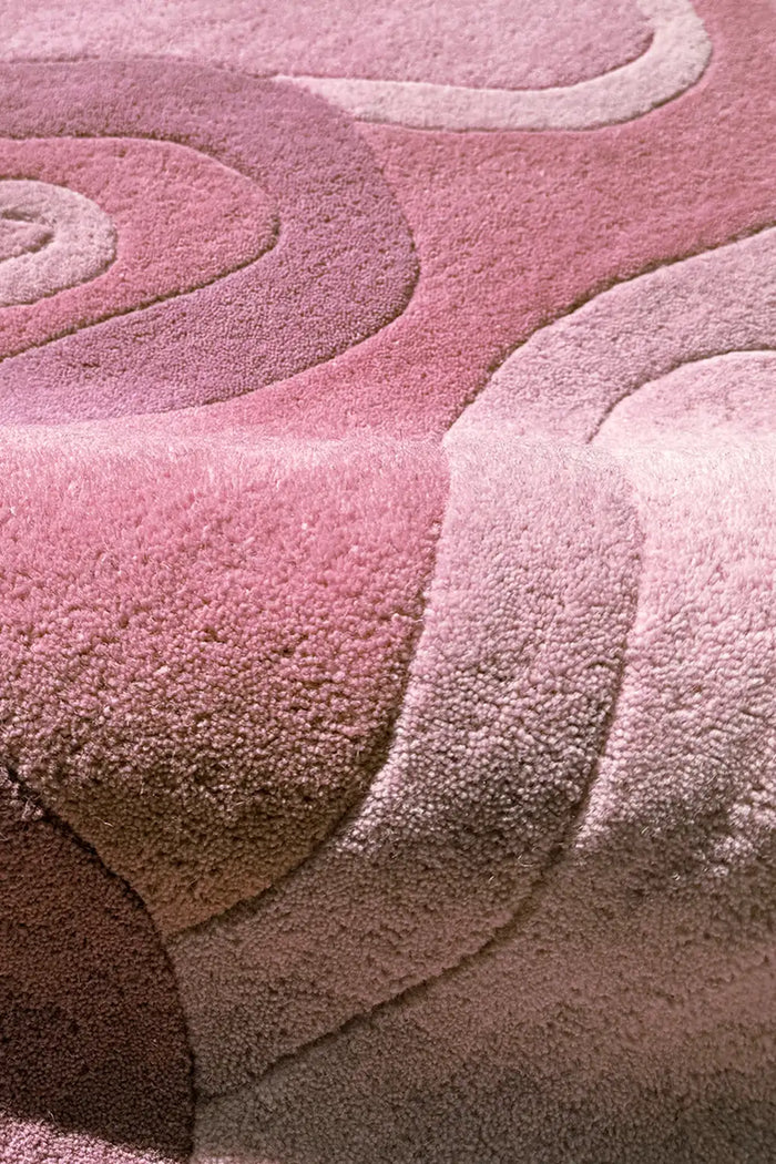 Hand-tufted rose pink rug with bold organic shapes and layered wool textures 