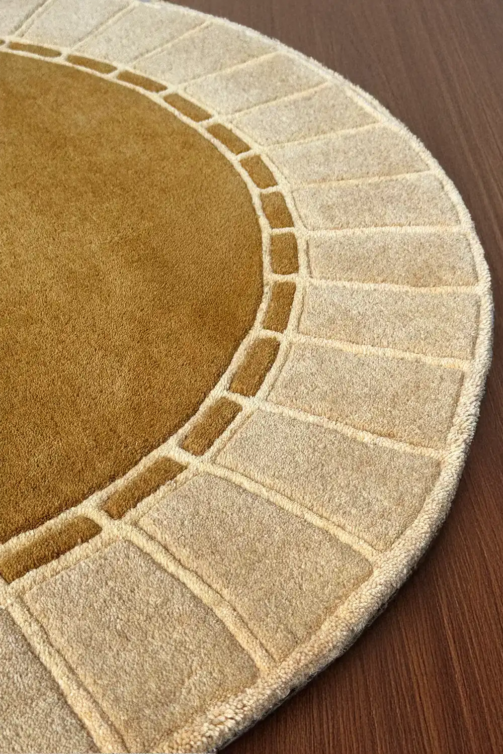 Raised architectural edge and arc detail on a neutral gold rug, ideal for boho or Scandinavian style living room decor