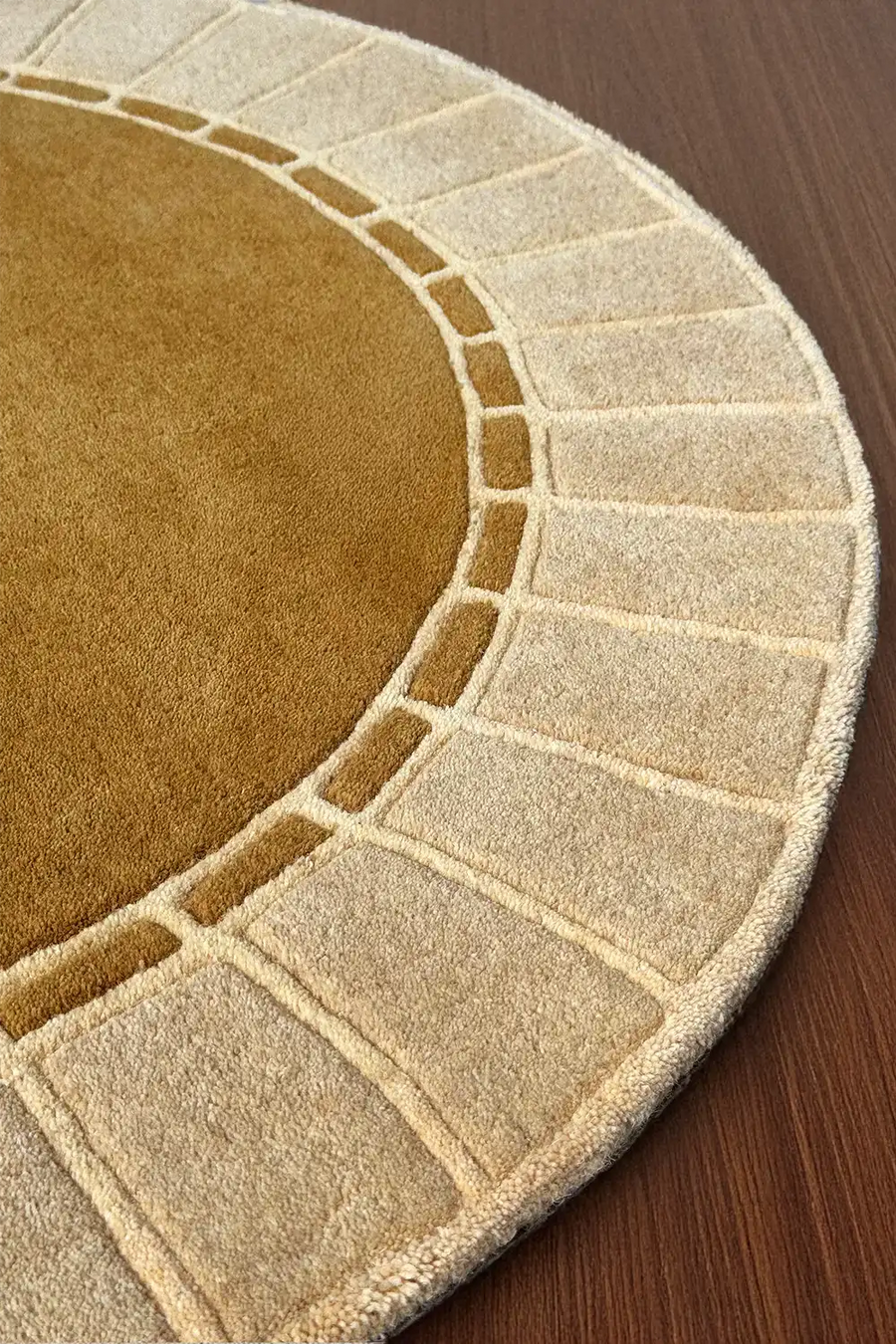 Raised architectural edge and arc detail on a neutral gold rug, ideal for boho or Scandinavian style living room decor