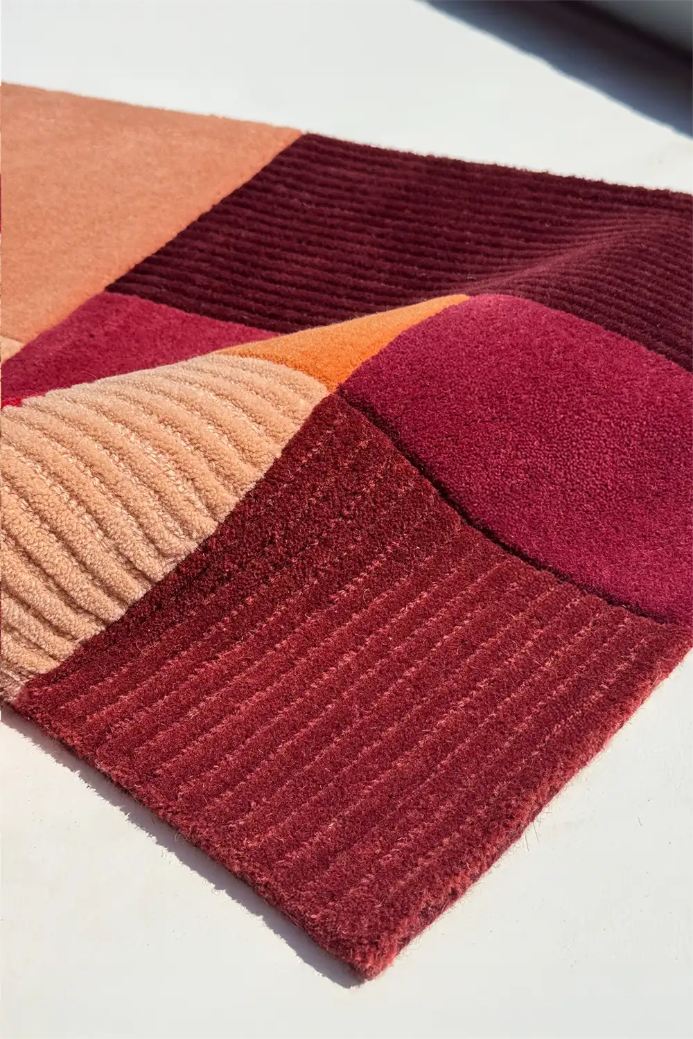 Colorful geometric-patterned rug on a light background