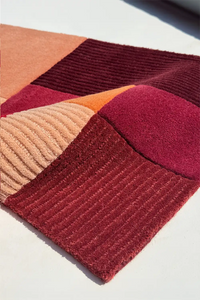 Colorful geometric-patterned rug on a light background