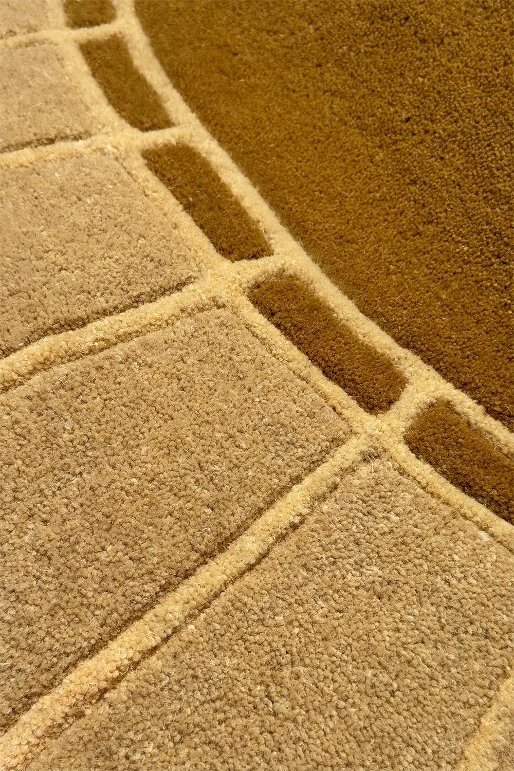 Taupe and camel tan border detailing on a hand-tufted modern arched rug, suitable as a unique 8x10 or 9x12 living room area rug