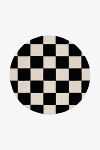 Round checkered rug with black and white pattern on a white background