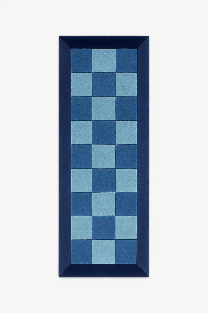 2x6 blue and light blue checkered runner rug with a dark blue border on a white background