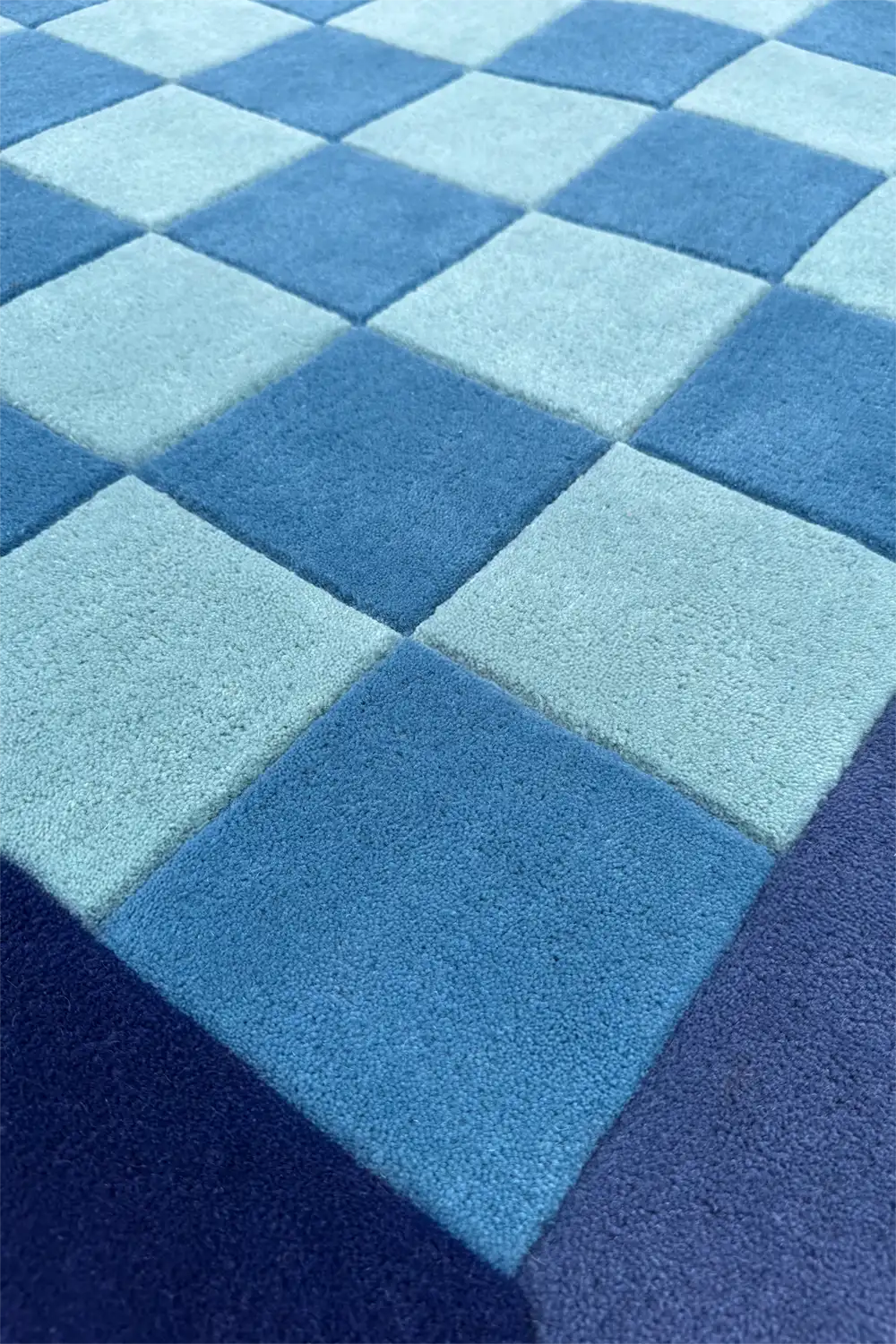 Blue and navy checkerboard patterned rug