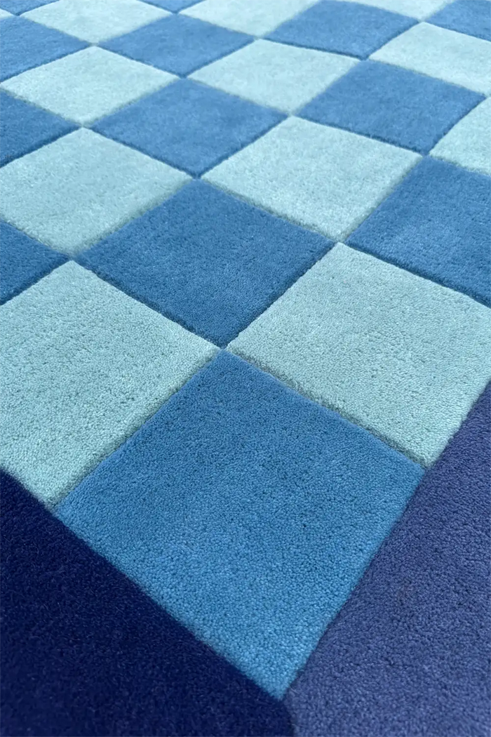 Blue and navy checkerboard patterned rug