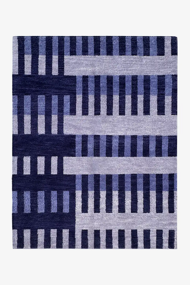wool area rug with blue and navy striped geometric pattern on a white background
