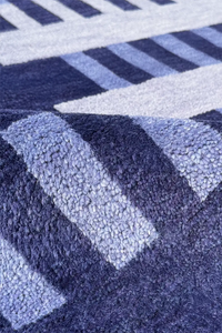 Close-up of a blue and navy geometric patterned wool handmade rug