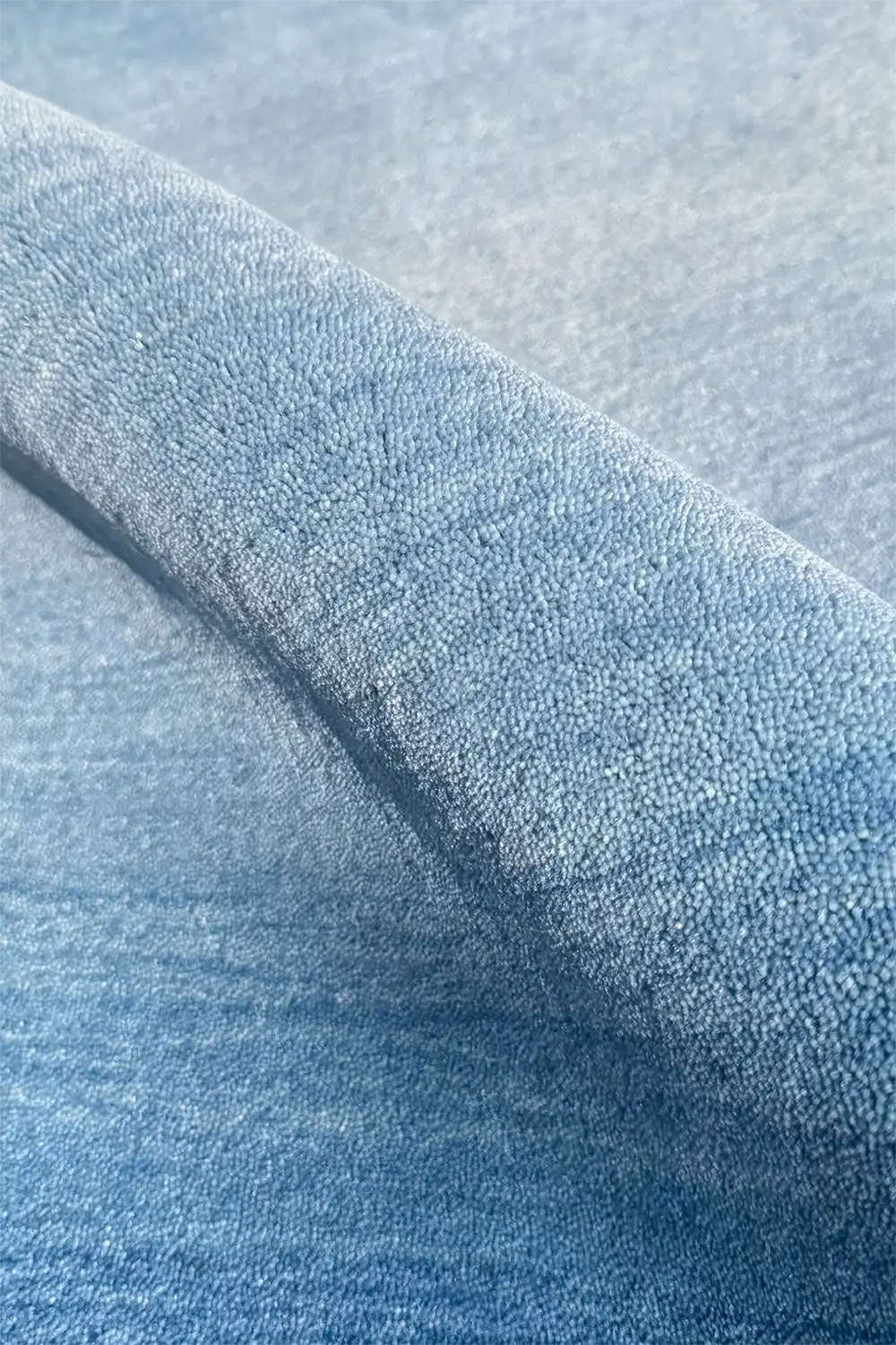 Close-up of textured light blue ombre wool modern hand loomed rug