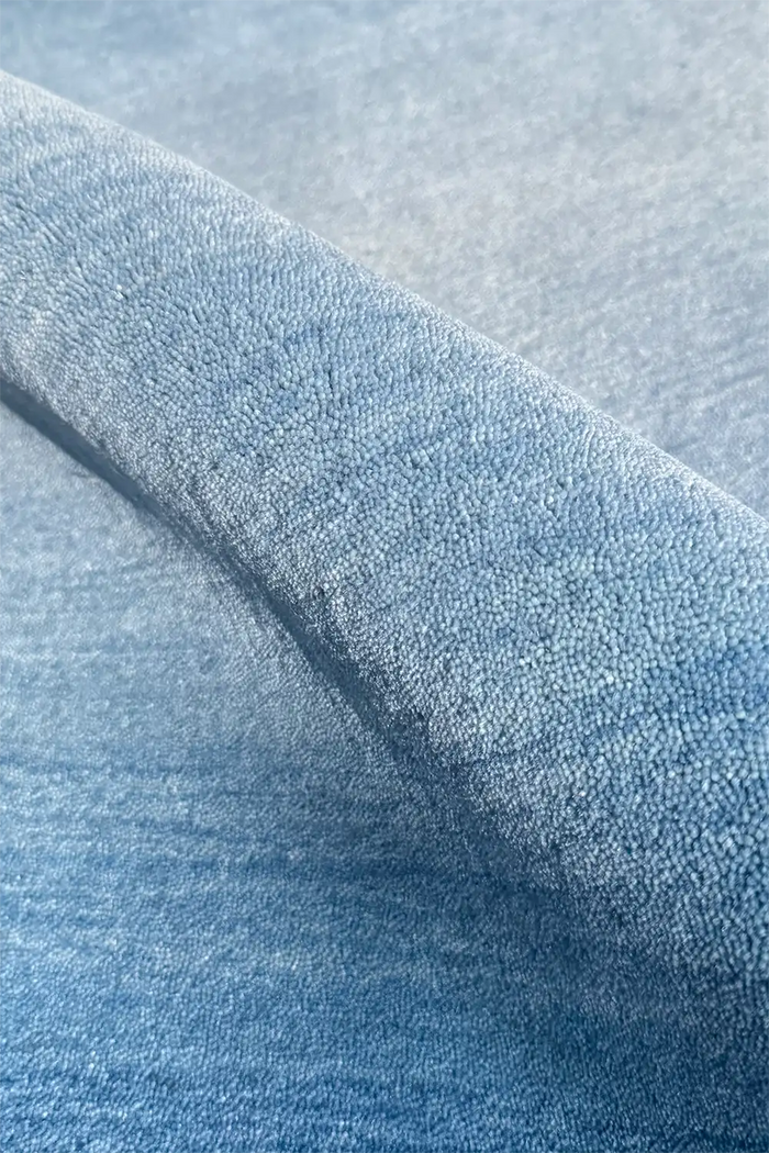 Close-up of textured light blue ombre wool modern hand loomed rug