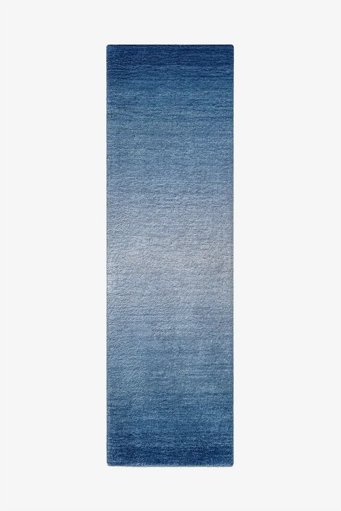 Blue gradient runner rug on a white background
