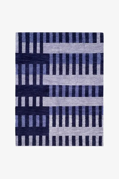 hand knotted rug with blue geometric pattern on a white background