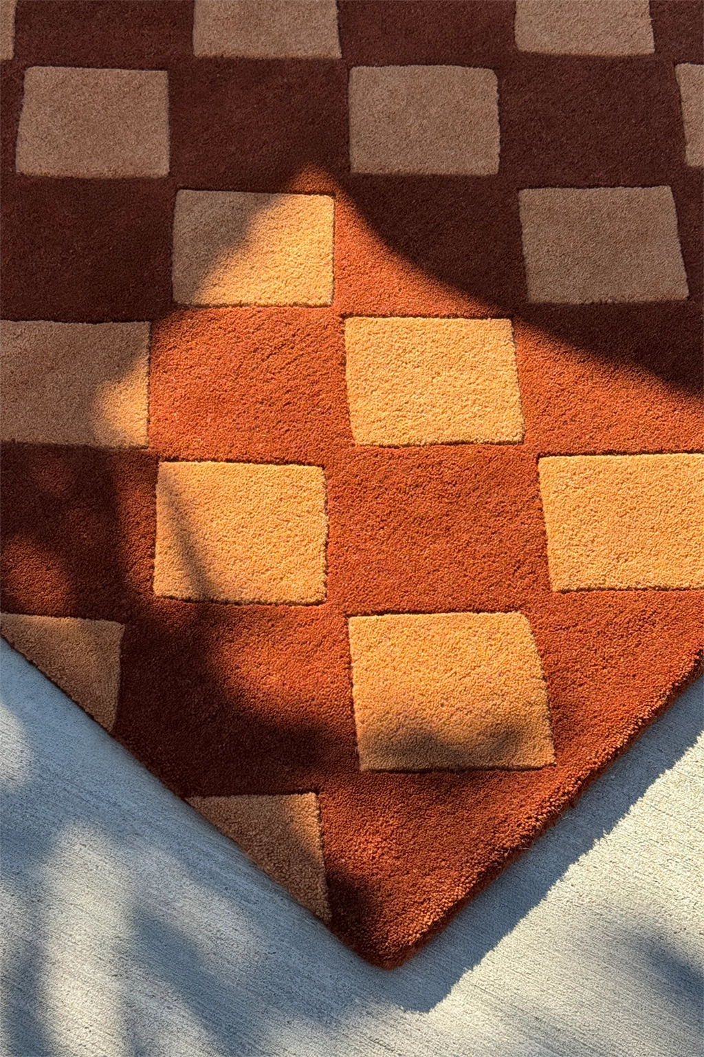 brown and gold geometric patterned wool rug with shadows