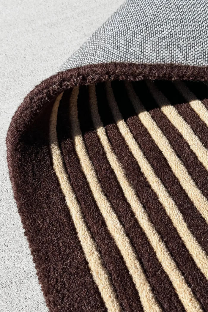 Hand-tufted wool rug with brown and multicolor stripes in an abstract linear layout