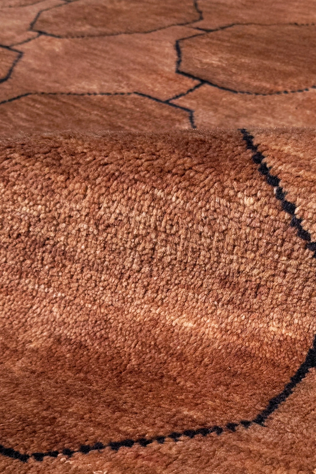 Close-up of a brown textured wool rug surface with black lines