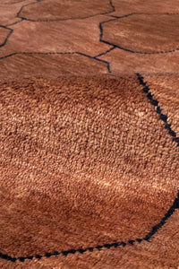 Close-up of a brown wool knotted rug texture surface with black lines