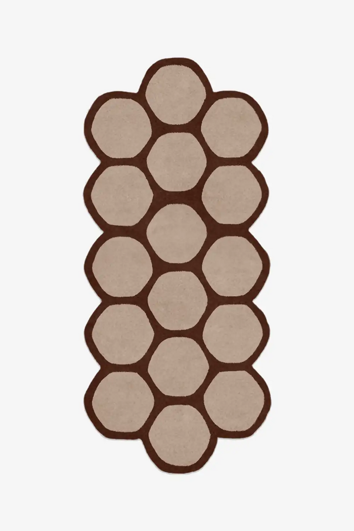 brown runner rug with hexagonal pattern on a white background